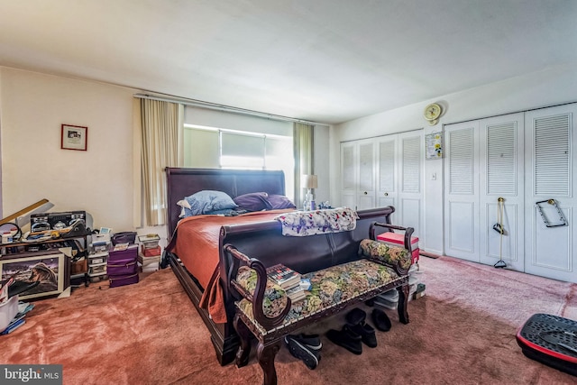 bedroom featuring multiple closets and carpet flooring