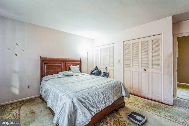 carpeted bedroom with multiple closets