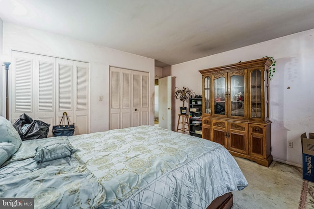 carpeted bedroom with multiple closets