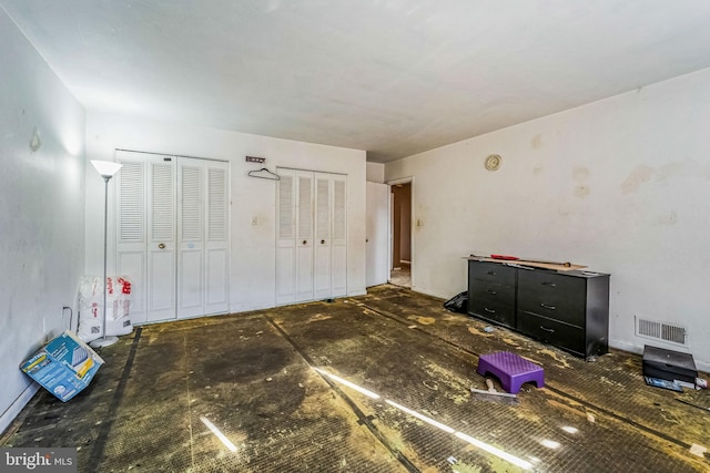 unfurnished bedroom featuring multiple closets