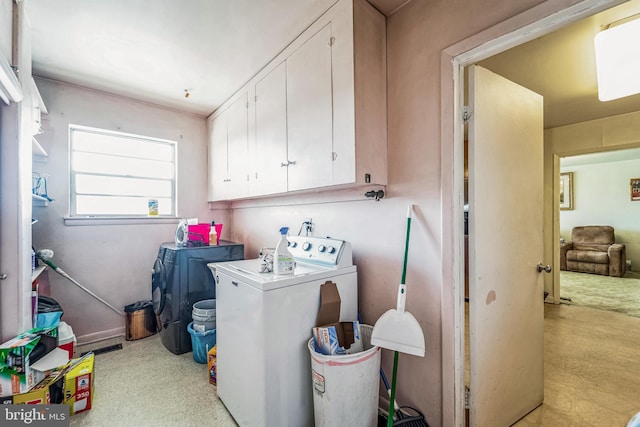 washroom featuring independent washer and dryer and cabinets