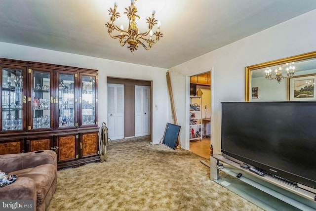 carpeted living room with a notable chandelier