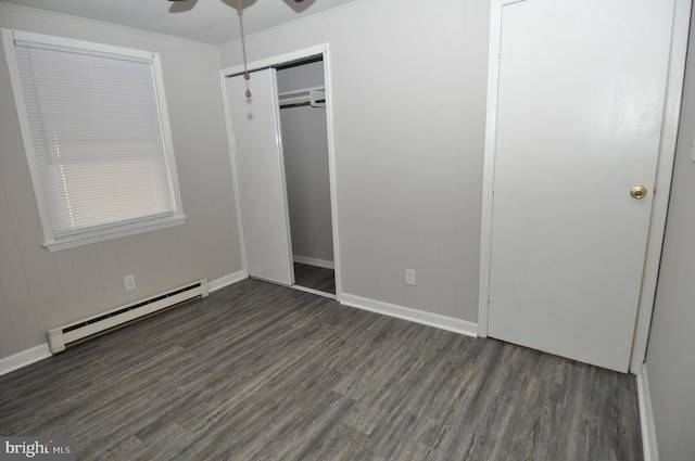 unfurnished bedroom with baseboard heating, ceiling fan, dark hardwood / wood-style flooring, and ornamental molding