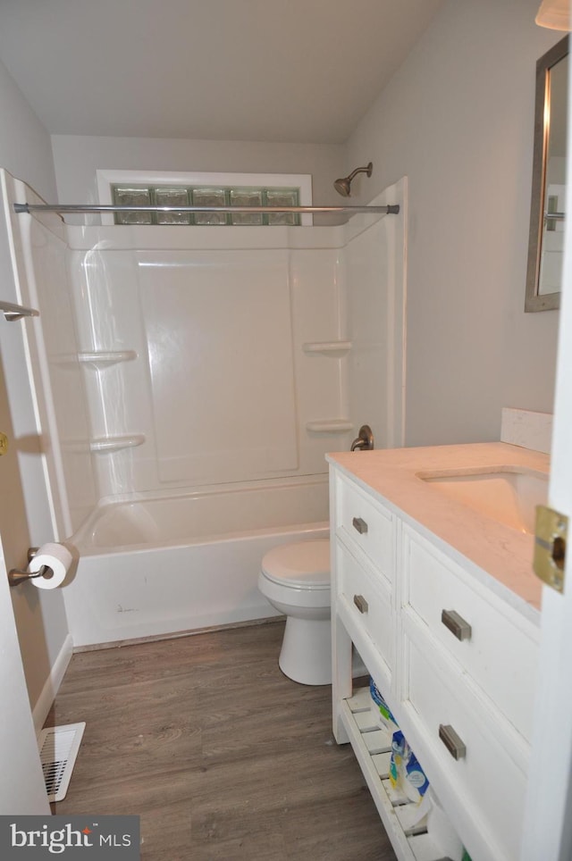 full bathroom featuring shower / bath combination, vanity, toilet, and wood-type flooring