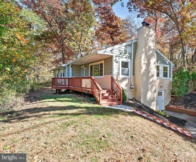 rear view of house with a lawn