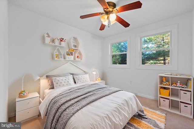 bedroom featuring ceiling fan and light colored carpet