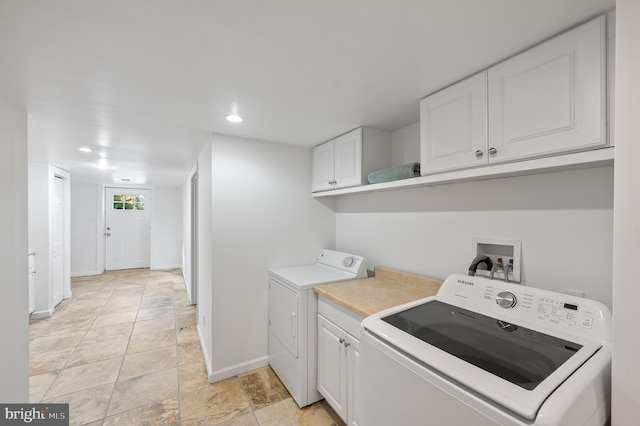 laundry room with washer and clothes dryer and cabinets