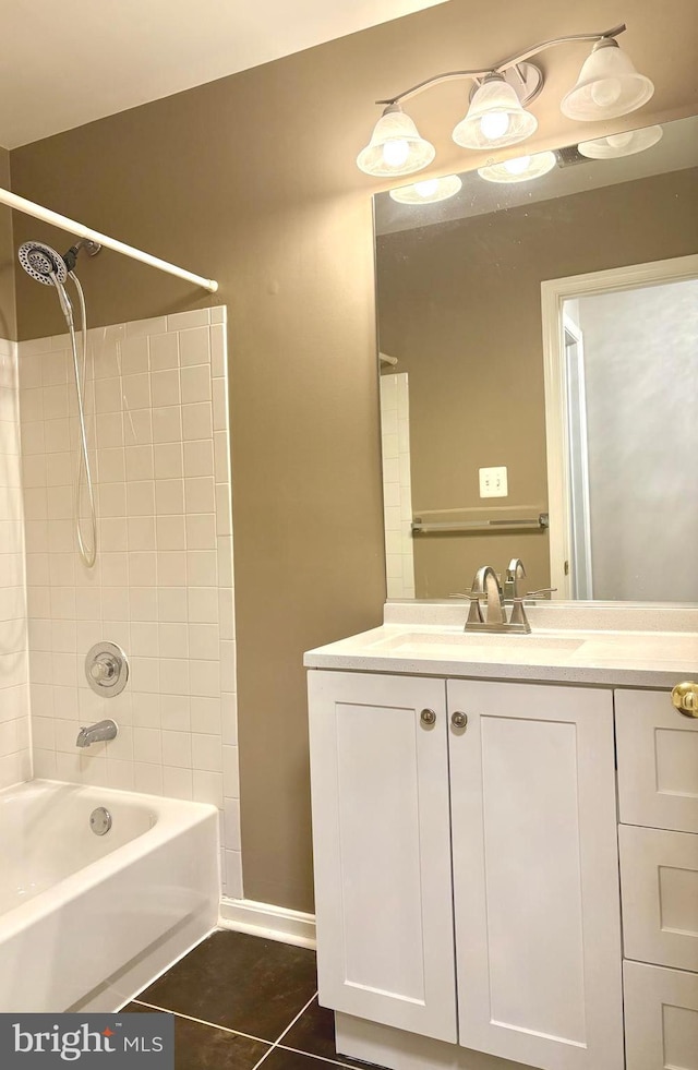 bathroom featuring tile patterned flooring, vanity, and tiled shower / bath combo