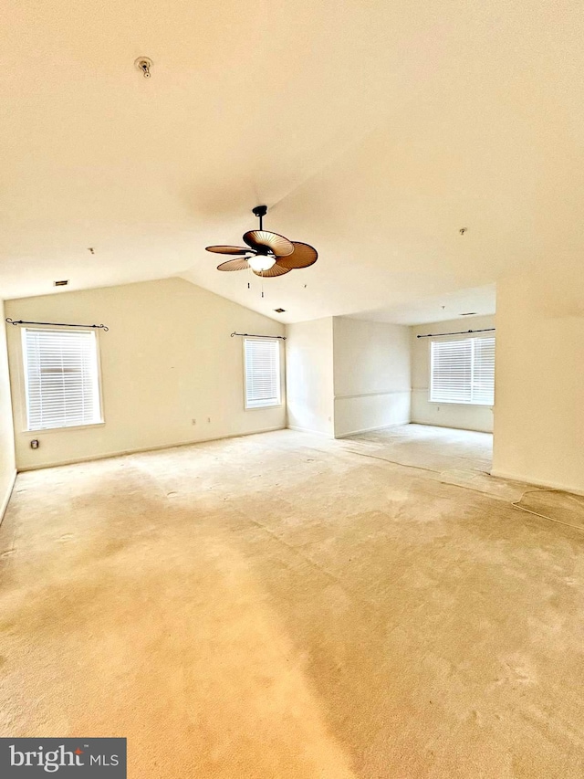 carpeted empty room featuring ceiling fan and lofted ceiling