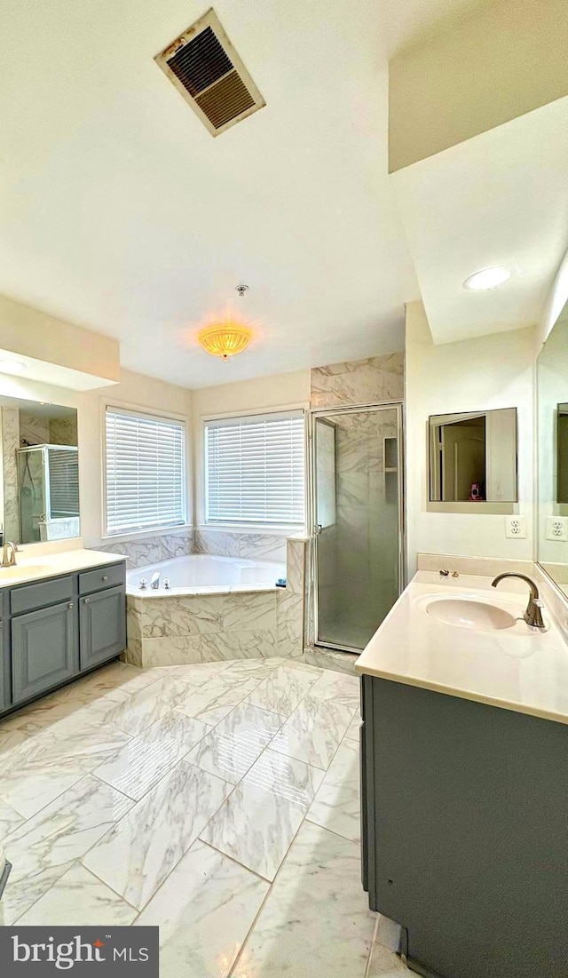 bathroom with vanity and separate shower and tub