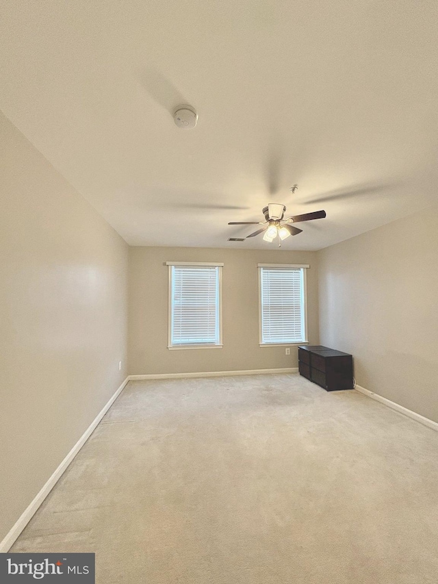 spare room with carpet floors and ceiling fan