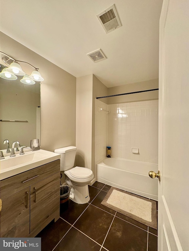 full bathroom featuring vanity, toilet, tiled shower / bath combo, and tile patterned flooring