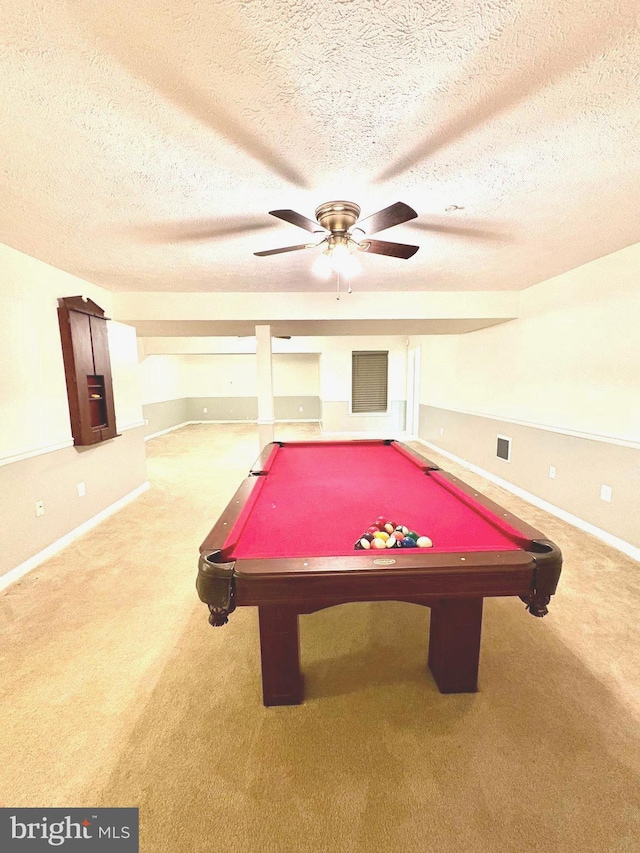 rec room featuring ceiling fan, a textured ceiling, and carpet