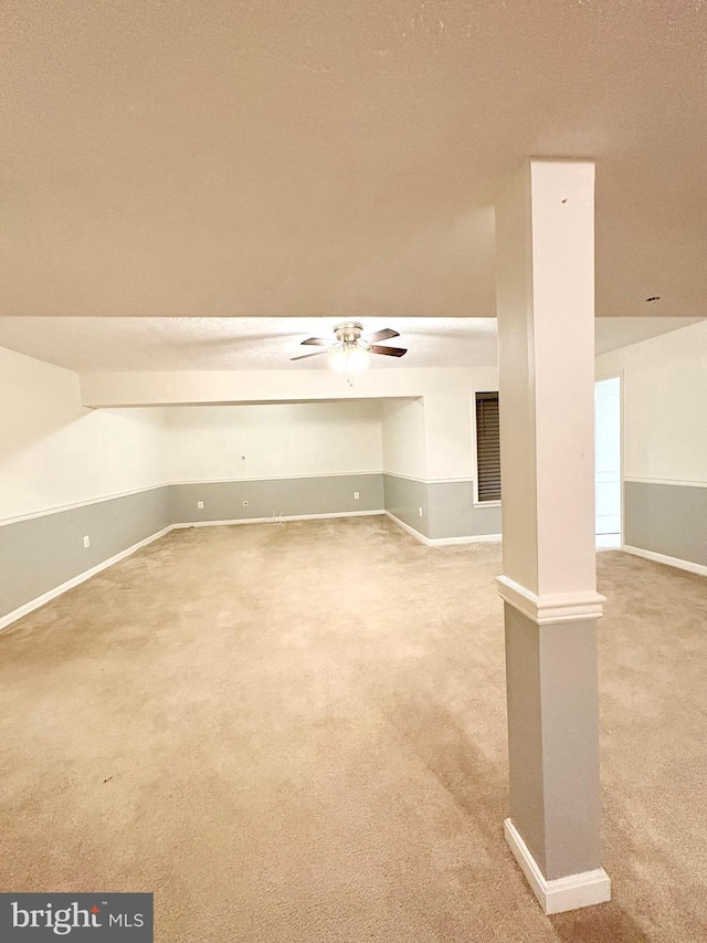 interior space with carpet flooring and ceiling fan