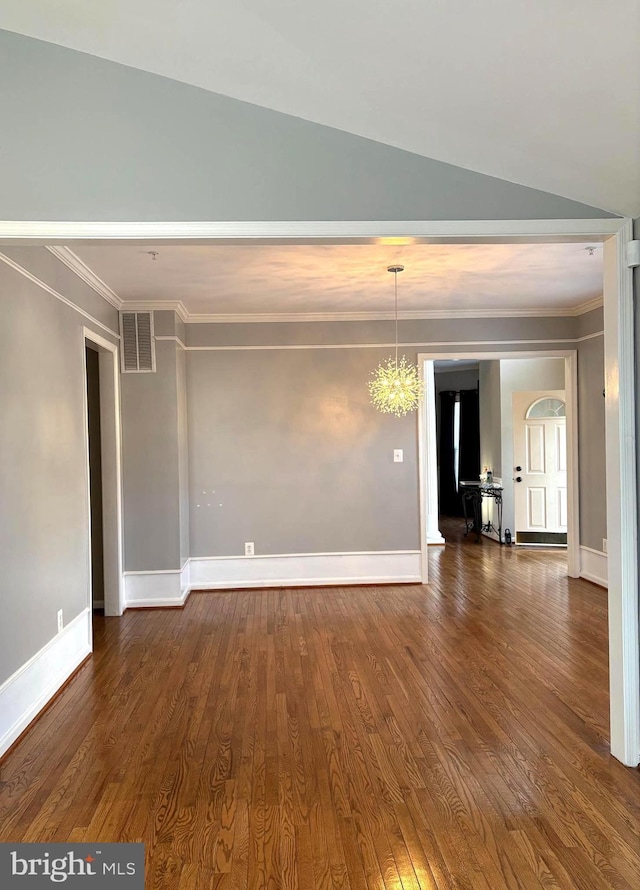 empty room featuring ornamental molding and dark hardwood / wood-style flooring