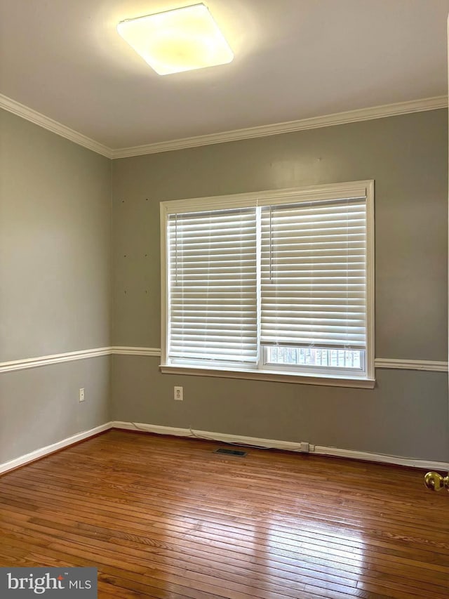 unfurnished room with crown molding and hardwood / wood-style floors