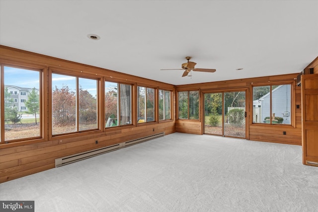 unfurnished sunroom with ceiling fan and baseboard heating