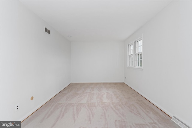 empty room featuring light colored carpet