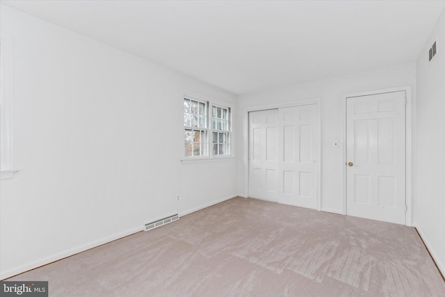 unfurnished bedroom featuring light colored carpet