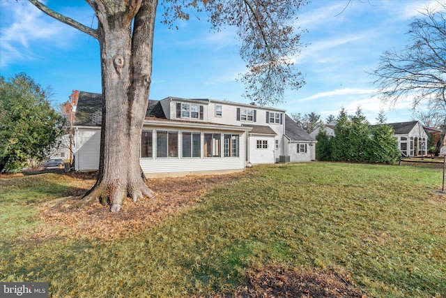 back of house featuring a sunroom and a yard