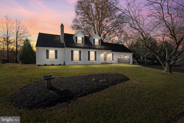 view of front facade with a yard and a garage