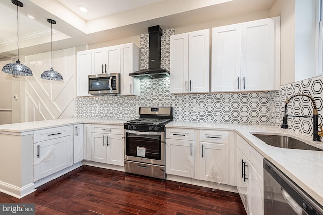 kitchen with white cabinets, wall chimney range hood, dark hardwood / wood-style floors, decorative backsplash, and stainless steel appliances