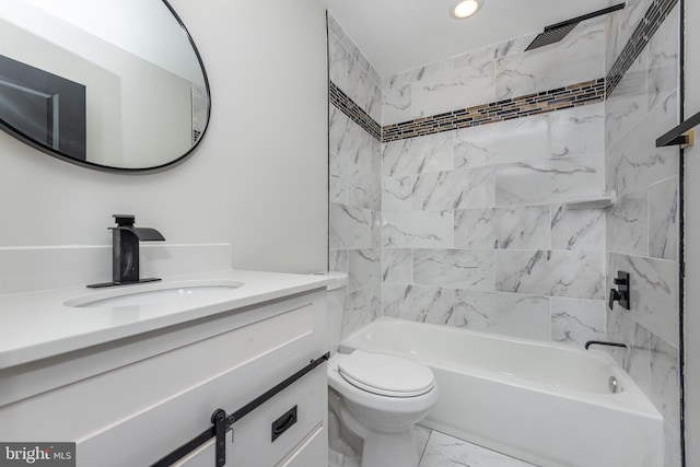 full bathroom with vanity, toilet, and tiled shower / bath