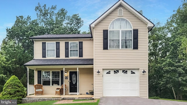 front of property featuring a garage and covered porch