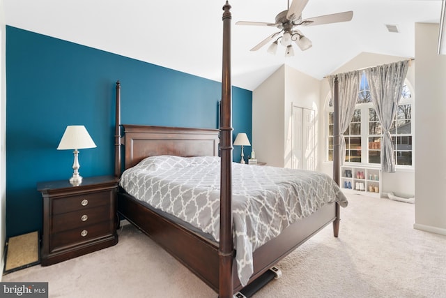 bedroom with ceiling fan, lofted ceiling, a closet, and light carpet