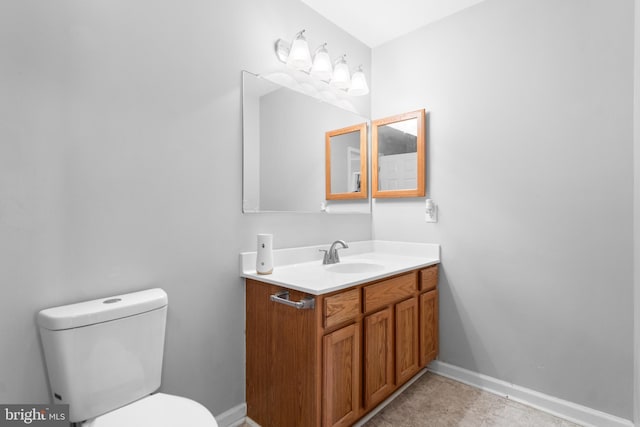 bathroom featuring vanity, tile patterned floors, and toilet