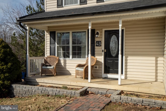 view of exterior entry featuring covered porch