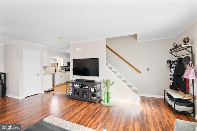 living room with ornamental molding and hardwood / wood-style floors