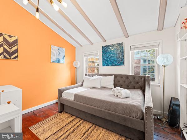 bedroom featuring lofted ceiling with beams and dark hardwood / wood-style flooring