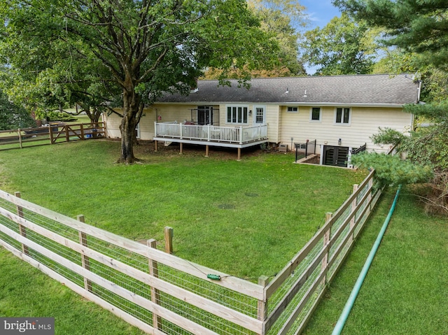 back of house with a lawn, a wooden deck, and central AC