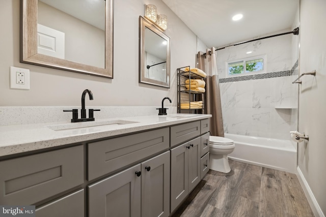 full bathroom featuring hardwood / wood-style floors, vanity, toilet, and shower / bath combo with shower curtain