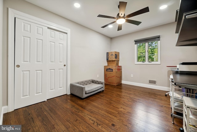 interior space with ceiling fan and dark wood-type flooring