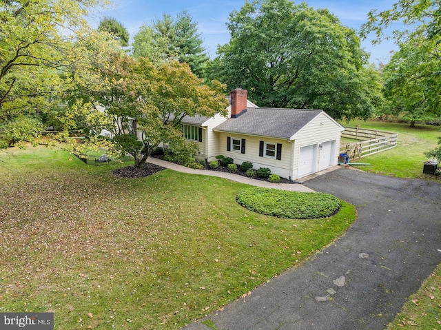 view of front facade with a garage and a front lawn