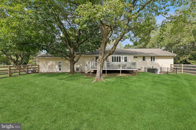 back of house featuring a deck and a yard