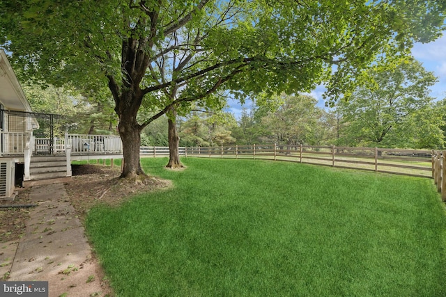 view of yard with a rural view and a deck