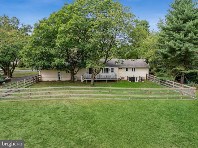 view of yard featuring a rural view, central AC unit, and a wooden deck