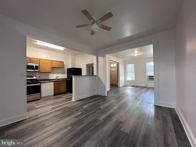 kitchen featuring ceiling fan, sink, dark wood-type flooring, and appliances with stainless steel finishes