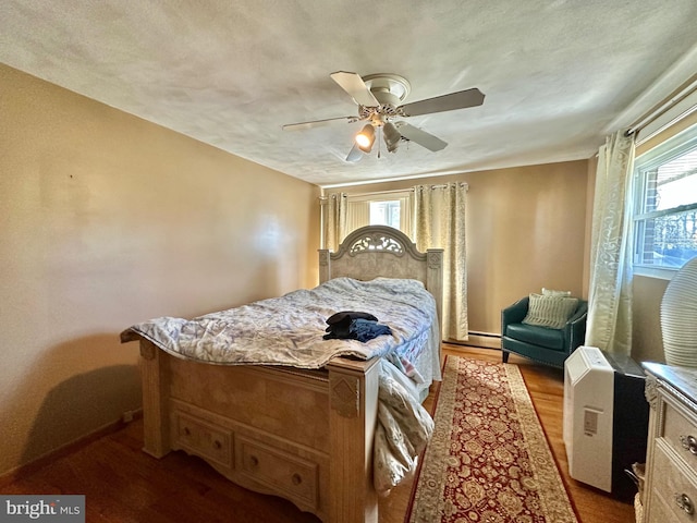 bedroom with a textured ceiling, light hardwood / wood-style flooring, and ceiling fan