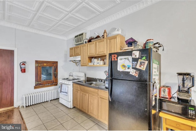 kitchen with radiator, black appliances, sink, light hardwood / wood-style flooring, and light brown cabinetry