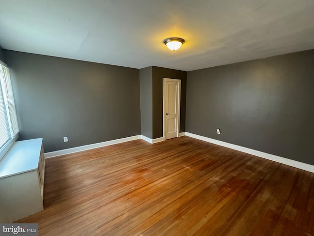 empty room with hardwood / wood-style floors