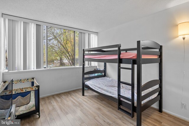 1824 Metzerott Unit B-5, Adelphi, MD 20783 - bedroom with a textured ceiling, wood finished floors, and baseboards