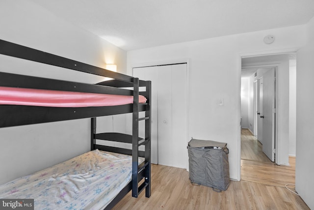 bedroom featuring light hardwood / wood-style flooring and a closet