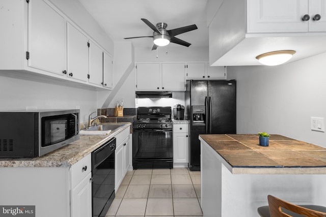 kitchen with black appliances, ventilation hood, sink, ceiling fan, and white cabinetry