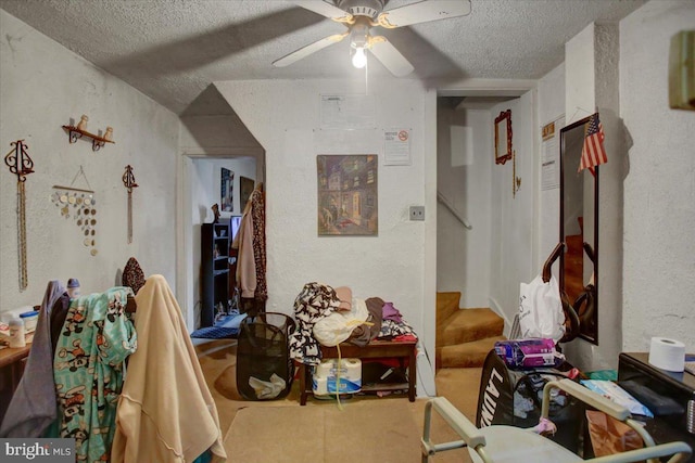 interior space with ceiling fan and a textured ceiling