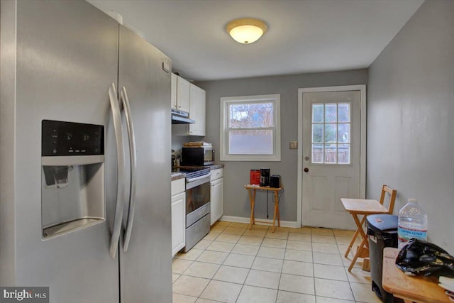 kitchen featuring white cabinetry, light tile patterned flooring, and stainless steel appliances