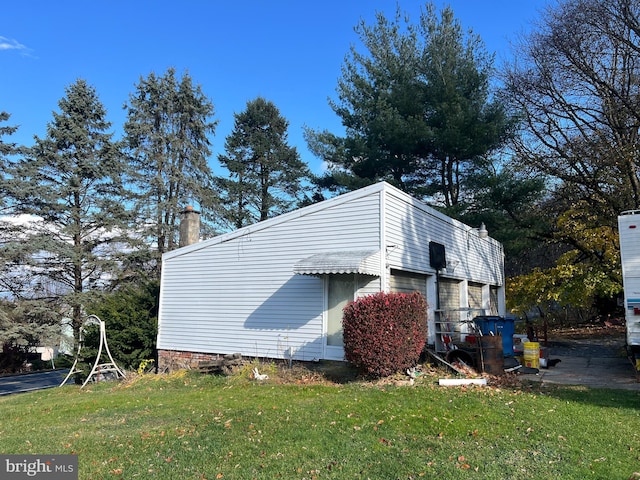 view of side of home featuring a lawn